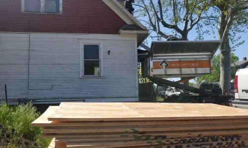 The device for the roof is at the house and there are boards nearby